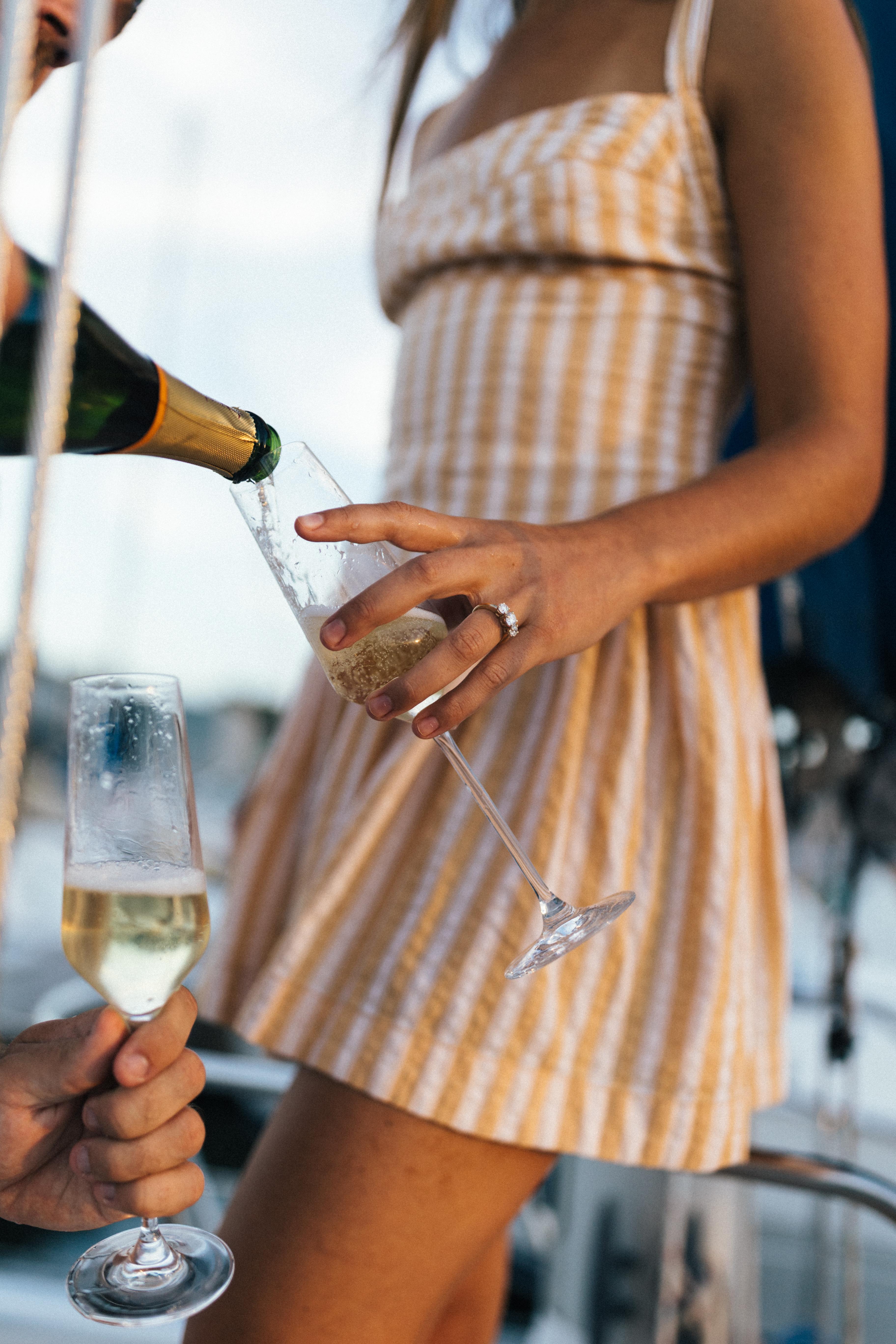 Champagne being poured into glasses at the harbor
